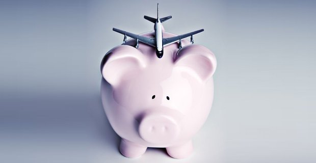 Piggy bank with airplane balanced on top